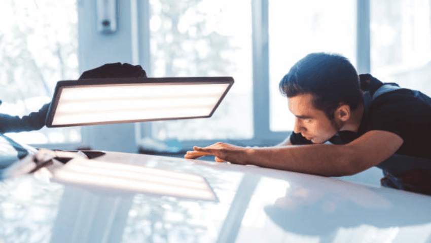 CARSTAR technician performing OEM-certified collision repair on a vehicle using manufacturer-approved equipment, diagnostic tools, and repair procedures.