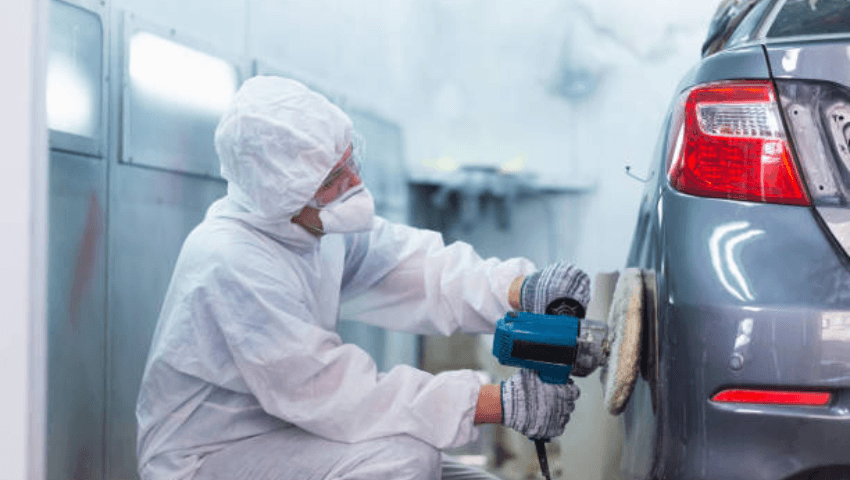 Vehicle undergoing collision repair at a CARSTAR certified body shop with technicians performing structural repairs and safety system diagnostics after an accident.